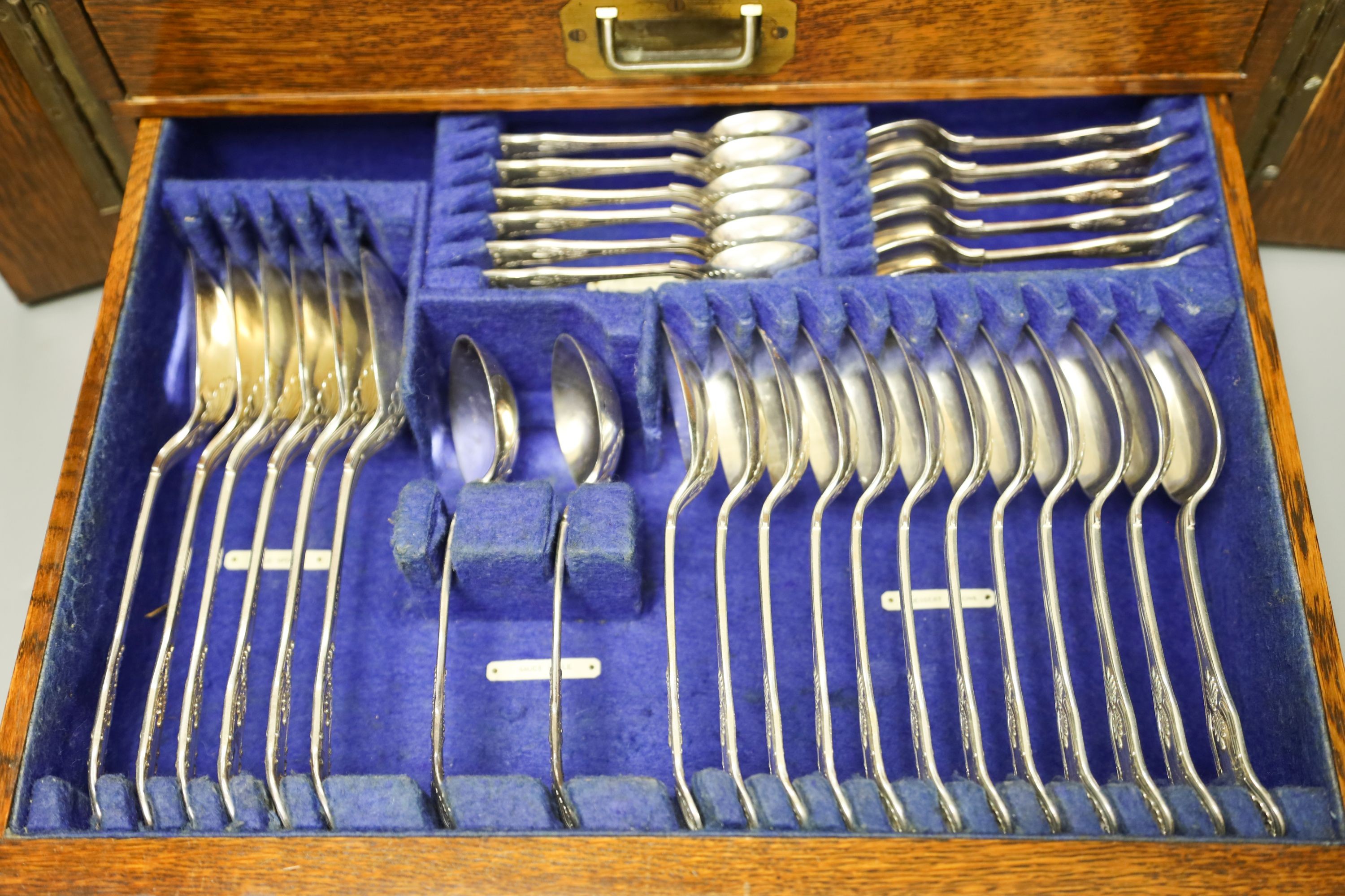 An Edwardian oak cased canteen of plated Kings pattern cutlery